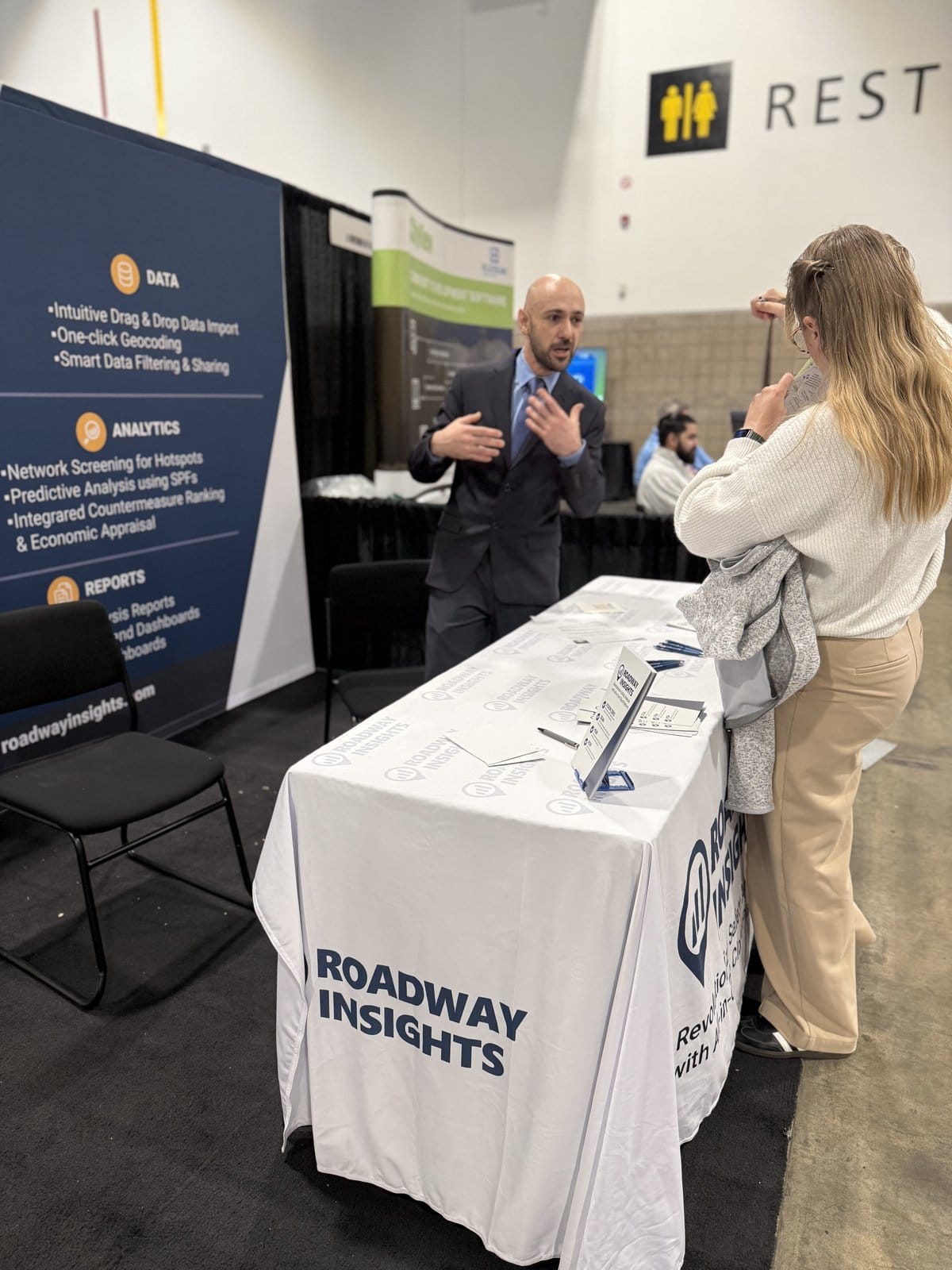 Conference attendees engaging at the Roadway Insights booth